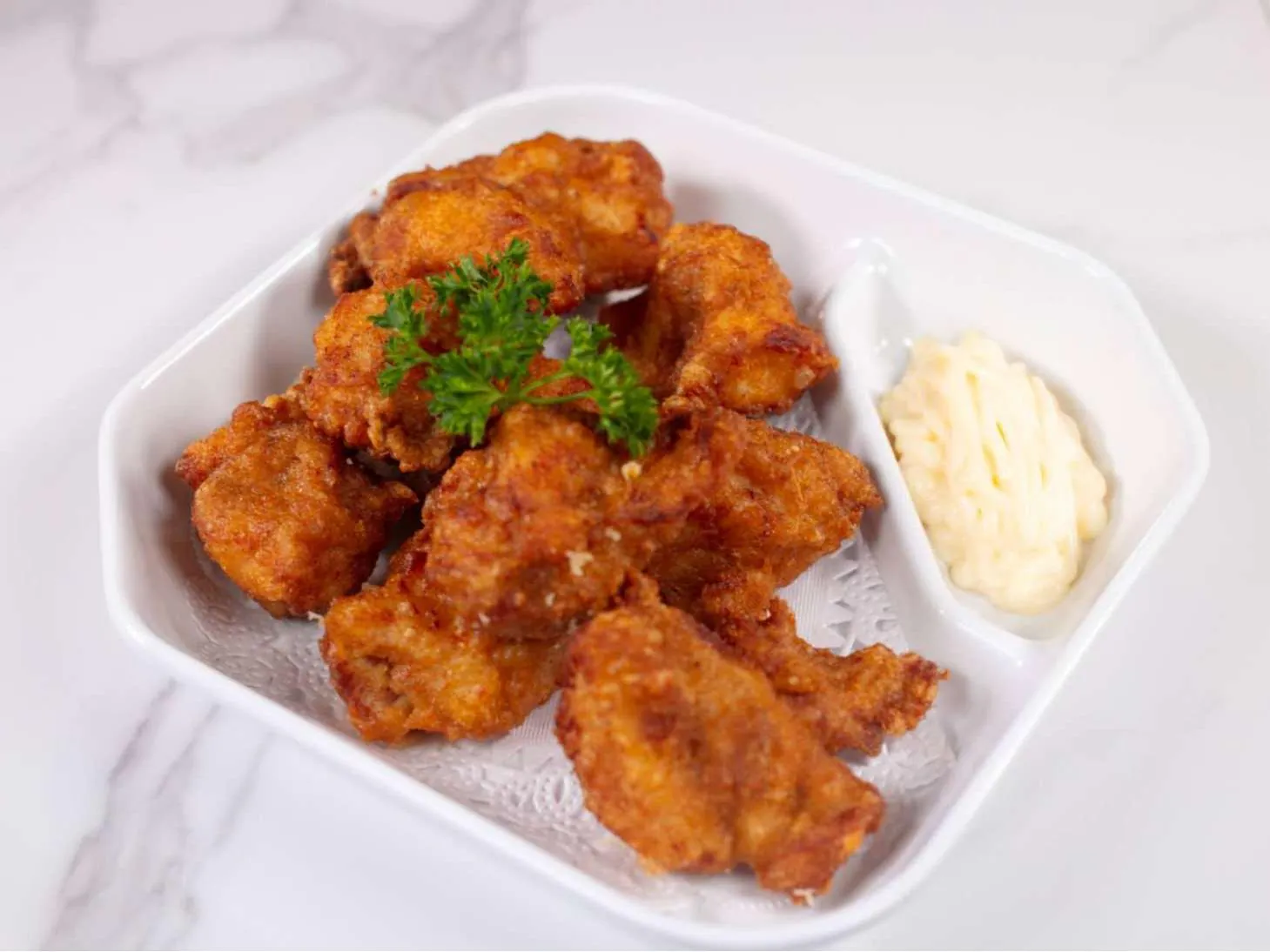 Crispy fried chicken bites served with creamy dipping sauce at Taki Sushi, a Japanese Restaurant in Toronto