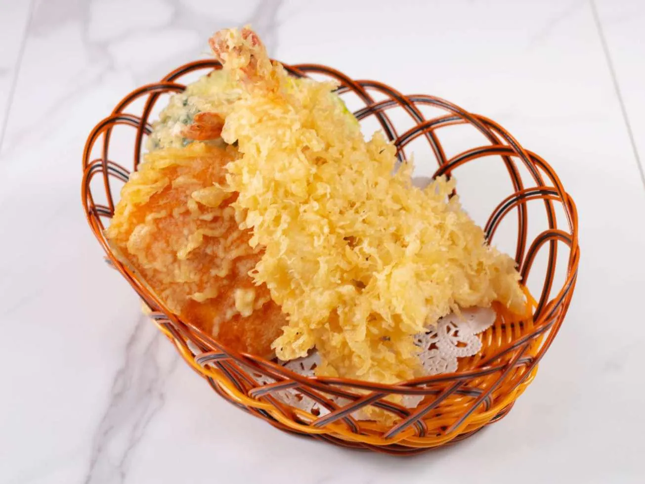 Light crispy tempura of shrimp & vegetables served in a basket at Taki Sushi, a Japanese Restaurant in Toronto