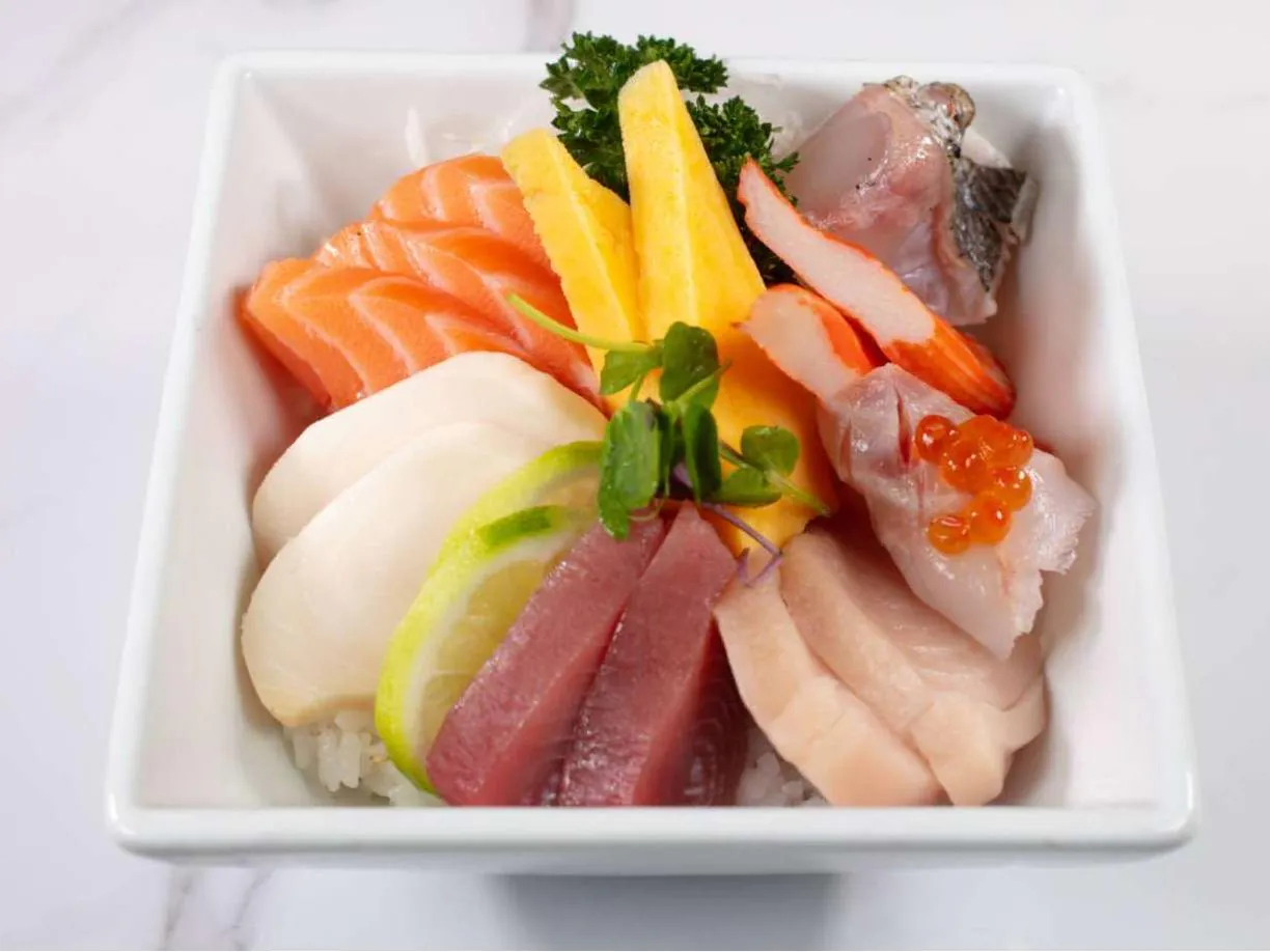 Assorted fresh sashimi over steamed rice, with mango & caviar at Taki Sushi, a Japanese Restaurant in Toronto